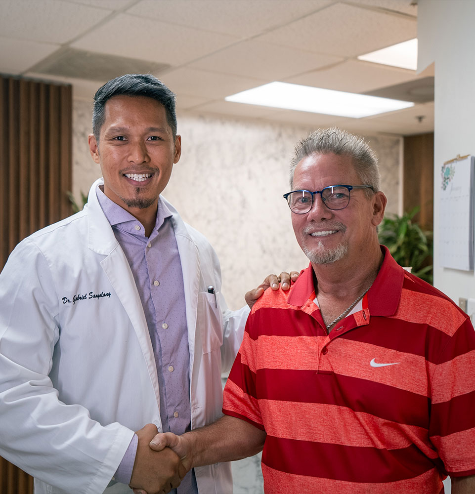 patient and doctor smiling together after patient's dental treatment